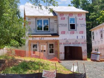 New home construction featuring protective wrap and visible framing at 1808 Falls Landing Dr, Raleigh, NC 27614
