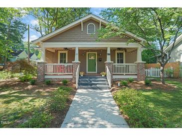 Charming craftsman home with covered front porch, landscaped yard, and inviting curb appeal at 211 W Trinity Ave, Durham, NC 27701