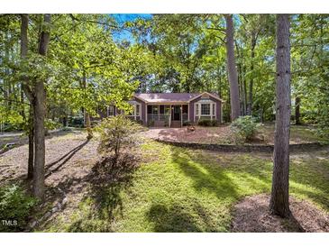 Charming home nestled among mature trees with a well-maintained lawn at 4816 Marlborough Way, Durham, NC 27713