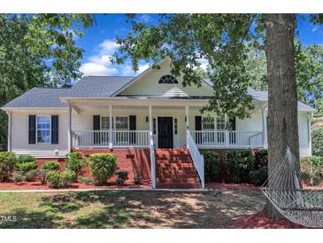 Charming single-Gathering home featuring a covered front porch with brick stairs and neatly landscaped surroundings at 52 Malcolm Dr, Clayton, NC 27520