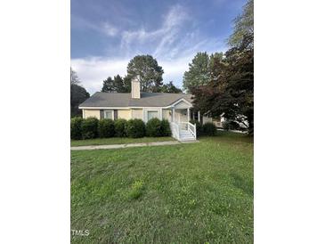 Charming single-story home with a well-manicured lawn and inviting front porch at 5809 Iris Lake Ct, Raleigh, NC 27604