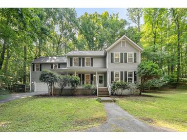 Charming two-story home with a cozy front porch and well-maintained landscaping at 10836 Wilmore Dr, Raleigh, NC 27614