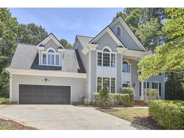 Charming two-story home boasts a well-manicured lawn, two-car garage, and inviting curb appeal at 110 Duckwood Ln, Cary, NC 27518