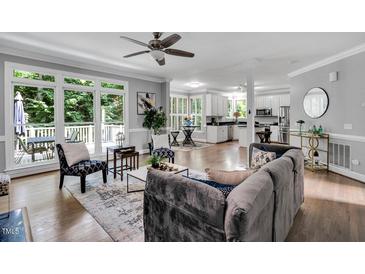 Open living room with hardwood floors, large windows, and stylish decor throughout at 12 Gatesway Ct, Durham, NC 27707