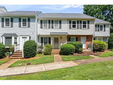 Charming townhouse with neat landscaping, sidewalk and traditional architectural details at 14 Quintin Pl, Durham, NC 27705