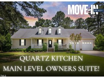 Charming one-story home with dormer windows, a two-car garage, a manicured lawn and inviting front porch at 3109 Gold Dust Ln, Willow Springs, NC 27592