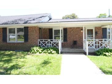 Charming brick ranch-style home with a cozy front porch and well-maintained landscaping at 521 S Lombard St, Clayton, NC 27520