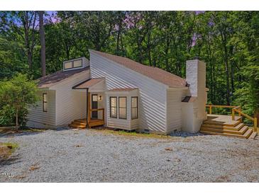 Charming exterior view of modern home with a wooden deck and a gravel driveway at 5709 Russell Rd, Durham, NC 27712