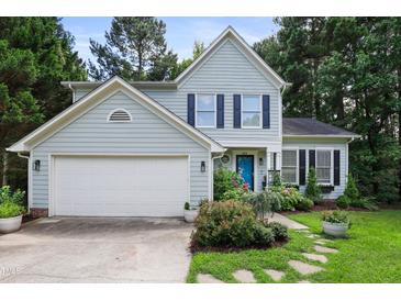 Charming two-story home with a blue front door and a beautifully landscaped front yard at 109 Crane Meadow Pl, Chapel Hill, NC 27514