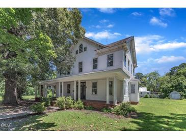 Charming two-story home with a large front porch and well-maintained landscaping at 118 N 7Th St, Smithfield, NC 27577