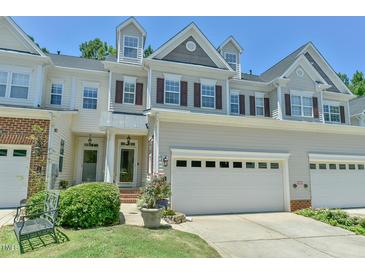 Charming townhome with two-car garage, manicured lawn, and classic architectural details at 119 Jones Creek Place Pl # 119, Chapel Hill, NC 27516