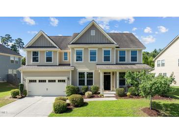 Charming two-story home featuring manicured landscaping and a welcoming front porch at 2120 Rainy Lake St, Wake Forest, NC 27587