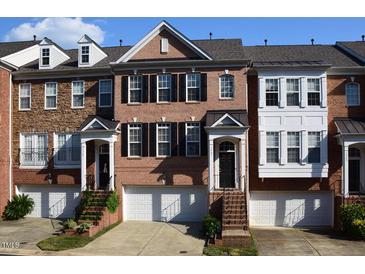 Charming brick townhome with black shutters, a one-car garage, and steps up to the front door at 2507 Princewood St, Raleigh, NC 27612