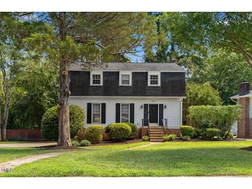Charming two-story home features a landscaped yard and classic architectural details at 3317 Harden Rd, Raleigh, NC 27607