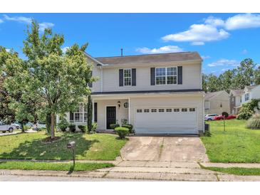 Charming two-story home featuring a two-car garage and landscaped front yard on a sunny day at 3604 Rivermist Dr, Raleigh, NC 27610
