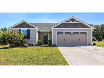 Charming single-story home with a well-manicured lawn and an attached two-car garage at 46 Bellini Dr, Angier, NC 27501
