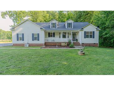 Charming home featuring a well-manicured lawn, white siding, inviting porch, and classic black shutters at 5307 Green Riley Rd, Rougemont, NC 27572