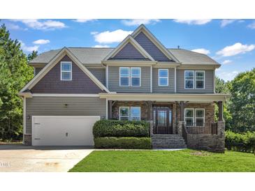 Charming two-story home with a beautifully landscaped front yard and welcoming front porch at 6332 Mountain Oaks Way, Wake Forest, NC 27587