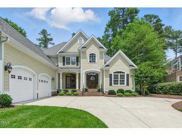 Charming two-story home with a three car garage, beautiful landscaping, and a well manicured lawn at 812 Bear Tree Crk, Chapel Hill, NC 27517