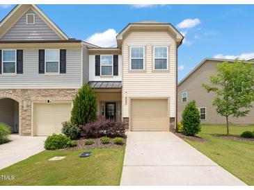 Charming townhome with a well-maintained lawn and attached one-car garage at 1137 Amber Shadow Dr, Durham, NC 27703