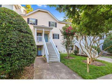 Inviting two-story condo with a light yellow exterior, black shutters, and landscaped front yard at 117 Scott Ln, Chapel Hill, NC 27514