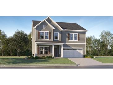 Charming two-story home with gray siding, stone accents, shutters, and a two-car garage at 182 E Fountainhead Ln, Garner, NC 27529
