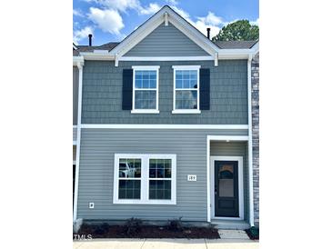 Charming townhouse with gray siding, black shutters, and well-maintained landscaping at 189 Seville Way, Clayton, NC 27520
