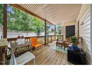 Relaxing back porch with wooden floors and comfortable seating for enjoying the outdoors at 2603 Stafford Ave # Apt C, Raleigh, NC 27607