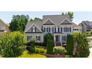 Inviting two-story home featuring well-manicured landscaping and classic architectural details at 307 Beacon Falls Ct, Cary, NC 27519