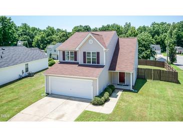 Charming two-story home featuring neutral siding, a well-manicured lawn, and an attached two car garage at 4125 Scofield Dr, Raleigh, NC 27610