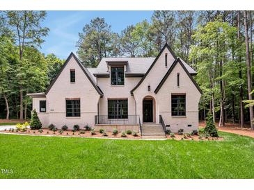 Charming two-story home featuring a brick facade, gabled roof, and lush landscaping at 503 Damascus Church Rd, Chapel Hill, NC 27516