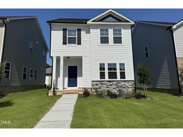 Charming two-story home with a well-maintained lawn and stone accents at 801 Portland Rose Dr, Knightdale, NC 27545