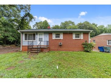 Cozy, brick home featuring a tidy front yard and welcoming entrance steps at 807 New St, Graham, NC 27253
