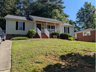 Charming single-story home with a well-maintained lawn and inviting front porch at 908 E Hudson Ave, Durham, NC 27704