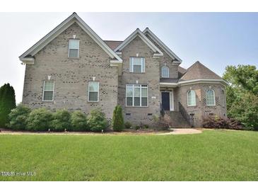 Charming two-story brick home featuring well-manicured landscaping and a welcoming entrance at 1126 Falling River Walk, Rocky Mount, NC 27804