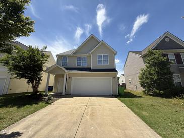 Charming two-story home featuring a spacious driveway and inviting front porch at 1618 Brownairs Ln, Raleigh, NC 27610