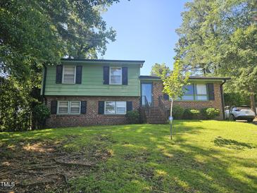 Charming two-story home with a brick facade and a well-manicured lawn in a shady neighborhood at 2308 Blacklan Cir, Raleigh, NC 27610