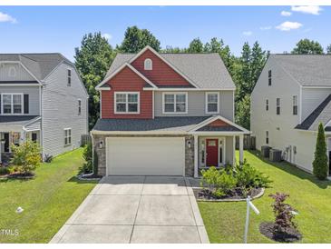 Charming two-story home featuring a two-car garage, well-maintained lawn and beautiful landscaping at 274 Marsh Creek Dr, Garner, NC 27529