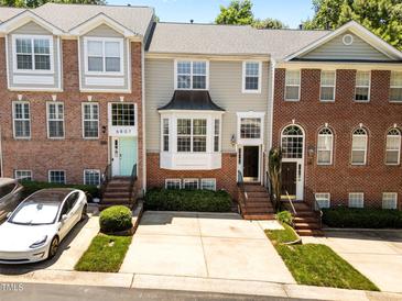 Charming townhouses feature brick facades, well-manicured landscaping, and inviting entrances at 6809 Middleboro Dr Dr, Raleigh, NC 27612