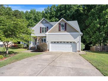 Charming two-story home features a two-car garage and meticulously maintained landscaping at 82 Finley Ct, Clayton, NC 27520