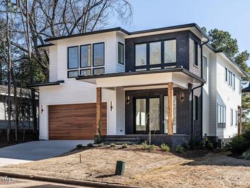 Striking modern two-story home featuring a mix of white siding and dark brick accents at 1009 Parker St, Raleigh, NC 27607