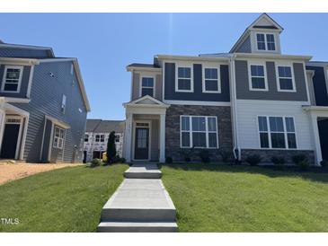Charming townhome with stone accents and a well-manicured lawn in a desirable neighborhood at 1563 Wendell Valley Blvd, Wendell, NC 27591