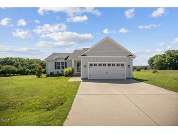 Charming single-Gathering home with well-manicured lawn and attached two-car garage at 174 Arrow Ln, Middlesex, NC 27557