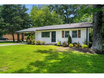 Charming brick home with a well-maintained lawn and mature trees, showcasing its inviting curb appeal at 313 13Th St, Butner, NC 27509