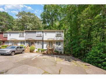 Charming townhome featuring neutral siding, wood stairs, and dedicated parking spaces at 3622 Colchester St # 17, Durham, NC 27707
