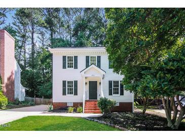 Charming two-story home with black shutters, landscaped front yard, and brick-lined entry at 4416 Lancashire Dr, Raleigh, NC 27613