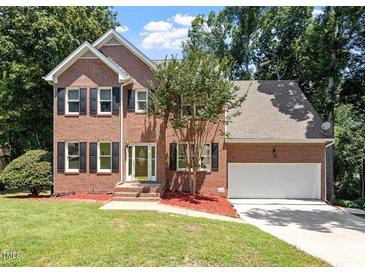Beautiful two-story brick home with a well-maintained lawn and attached two-car garage at 4733 Royal Troon Dr, Raleigh, NC 27604
