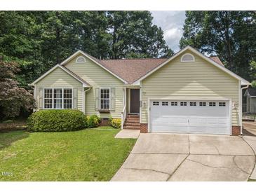 Charming single-story home with a well-manicured lawn, two-car garage and traditional architectural details at 6205 Houndsman Ct, Raleigh, NC 27616