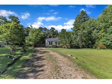 Charming single-story home featuring a well-maintained lawn, gravel driveway, and inviting curb appeal at 109 Mill Creek Dr, Youngsville, NC 27596