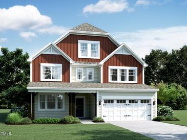 Charming two-story home featuring a covered front porch and attached two-car garage, nicely landscaped at 1204 Sparkling Lake Dr # 20, Apex, NC 27523
